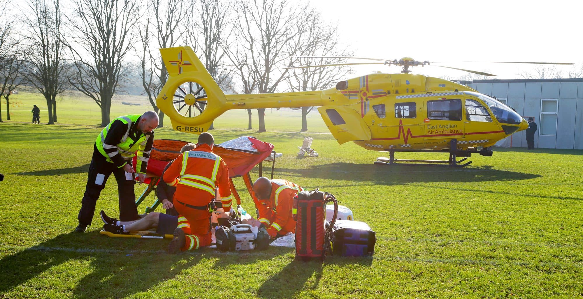 MedAir Global air ambulance aircraft on tarmac at sunrise, ground crew performing pre-flight safety checks, ambulance vehicle alongside