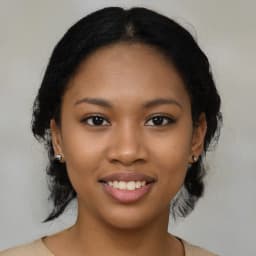 Smiling woman in her 40s, casual attire, warm background